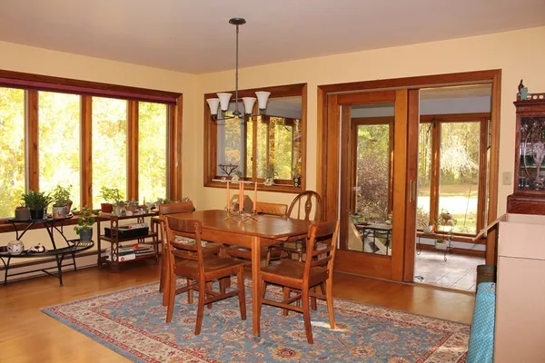 a view of a dining room with furniture window and wooden floor