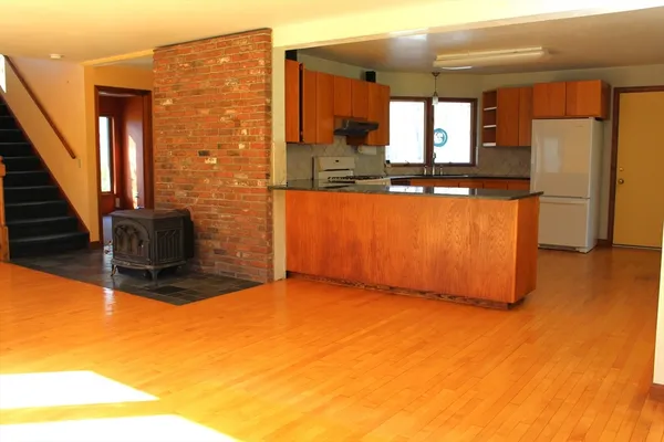 a view of kitchen with stainless steel appliances granite countertop cabinets and a potted plant