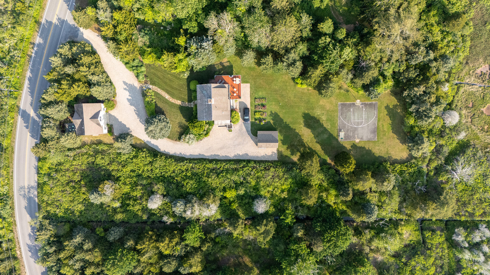 a aerial view of a house with a yard and large trees
