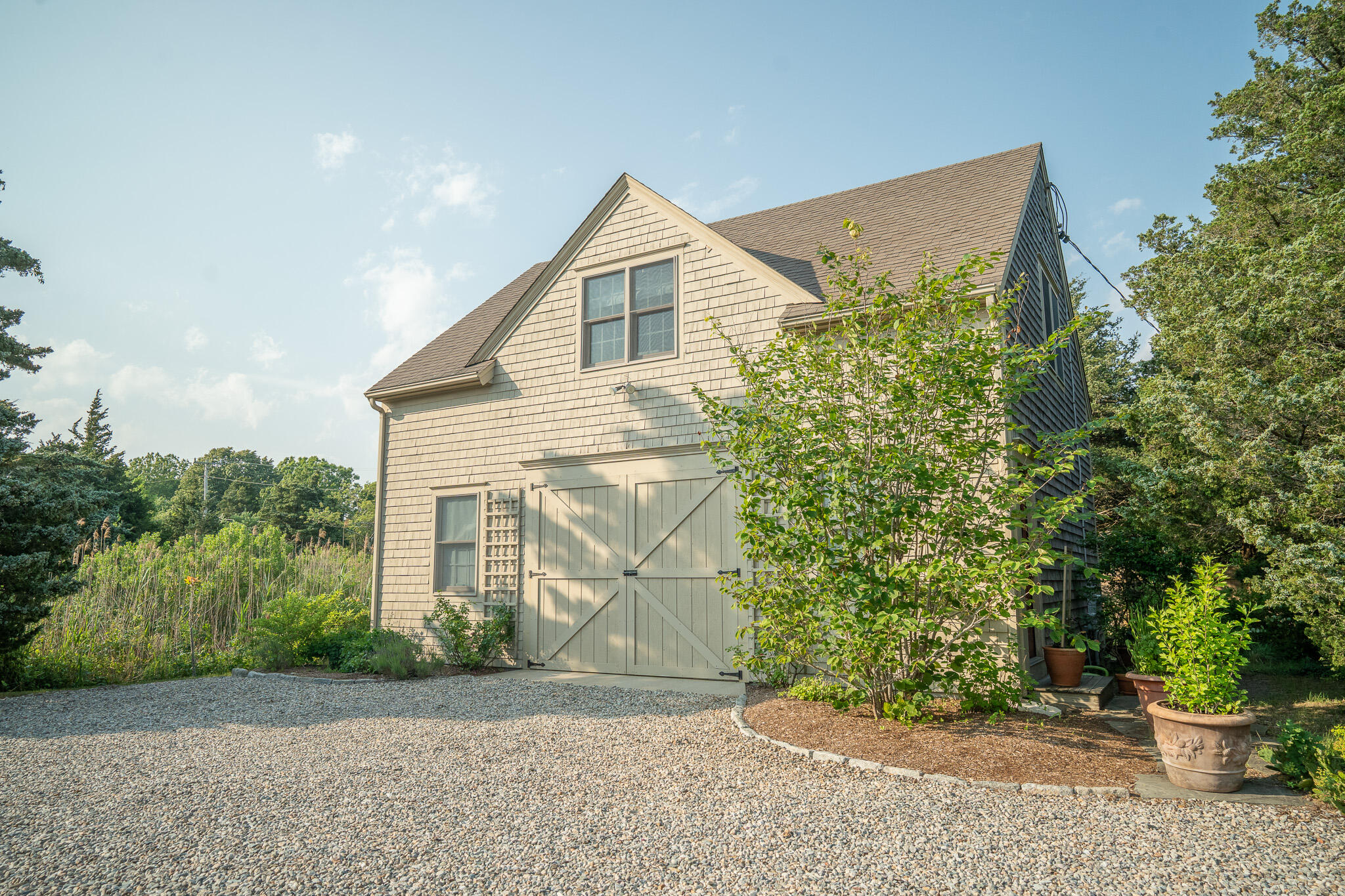 625 Bridge Road Eastham, MA 02642 - Photo 61 of 104 a front view of a house with a yard and potted plants
