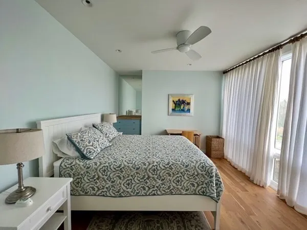 a bedroom with a large bed and a window