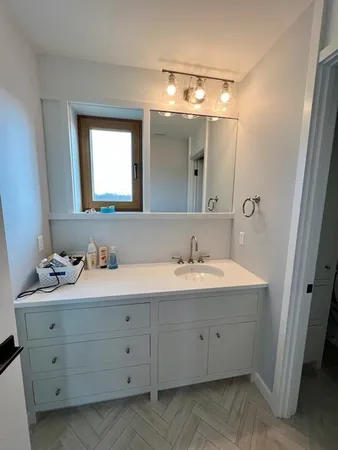 a bathroom with a double vanity sink and mirror
