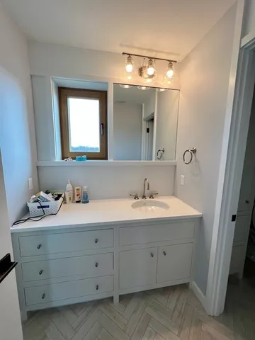 a bathroom with a double vanity sink and mirror