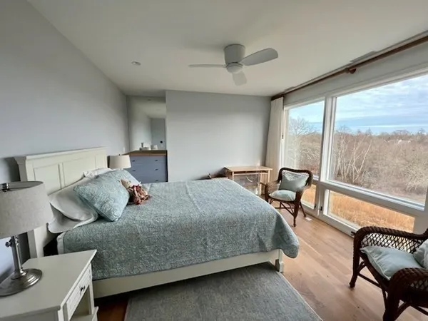 a bedroom with a bed and a large window