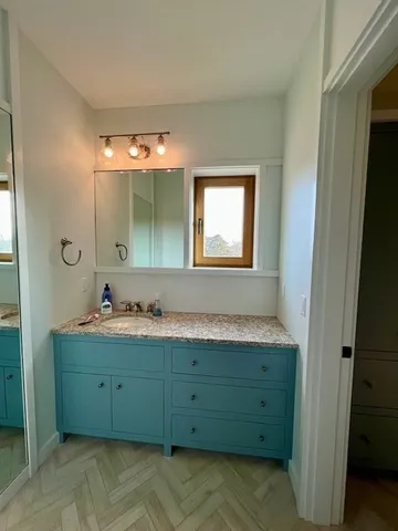 a bathroom with a double vanity sink and mirror