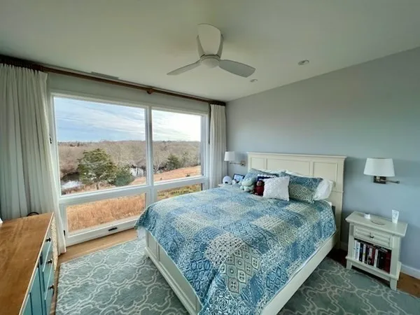 a bedroom with a large bed and a window