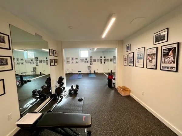a room with gym equipment and a view of living room
