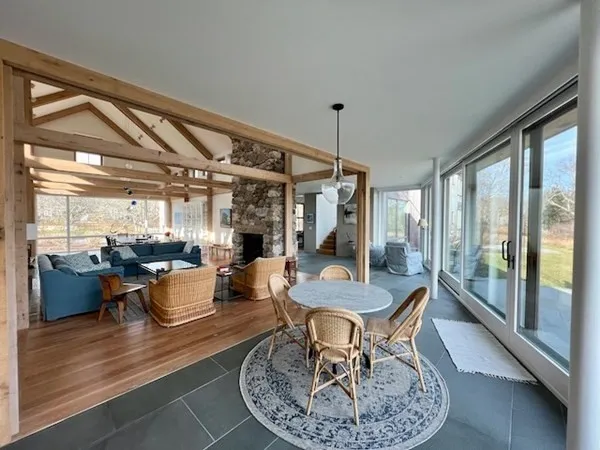 a dining room with furniture a chandelier and wooden floor