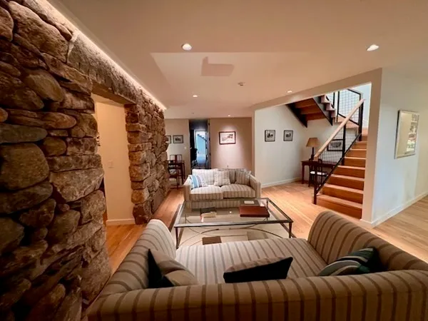 a living room with furniture and stairs