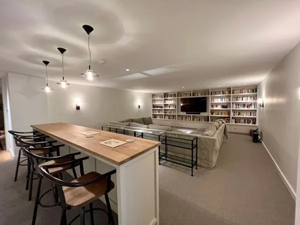 a view of a dining room with furniture and a kitchen