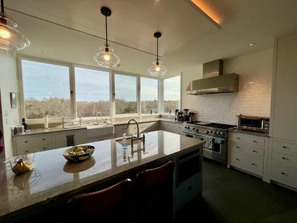 a kitchen with sink stove and cabinets