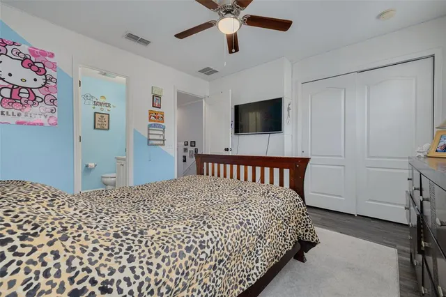 a bedroom with a bed and a flat screen tv