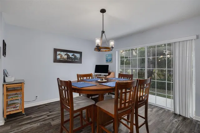 a view of a dining room with furniture wooden floor and chandelier