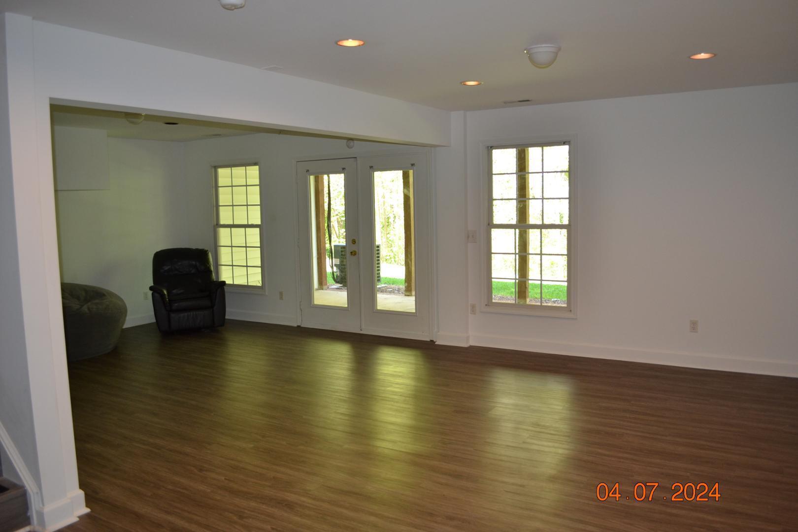 4506 Mistiflower Drive Raleigh, NC 27606 - Photo 22 of 27 a view of empty room with wooden floor and fan