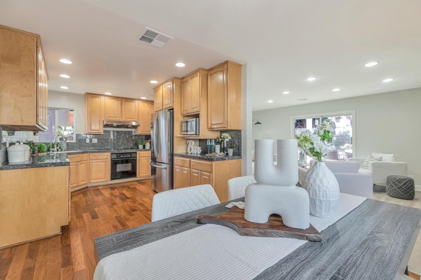 152 Brian Lane Santa Clara, CA 95051 - Photo 18 of 76 a living room with kitchen island furniture and a view of kitchen