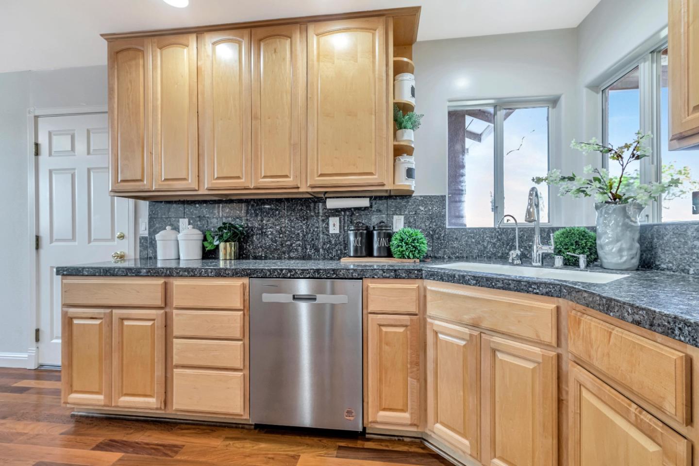 152 Brian Lane Santa Clara, CA 95051 - Photo 26 of 76 a kitchen with granite countertop wooden cabinets a sink and dishwasher with wooden floor