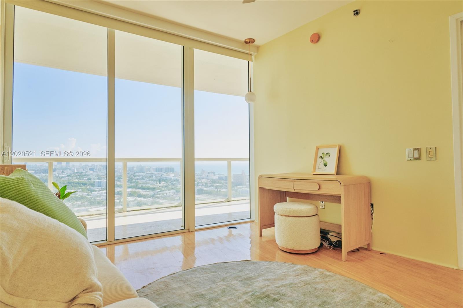 450 Alton Road, Unit 2810 Miami Beach, FL 33139 - Photo 16 of 29 a bedroom with a bed and glass door