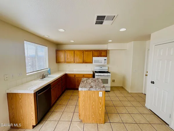 a kitchen with stainless steel appliances granite countertop a sink and cabinets