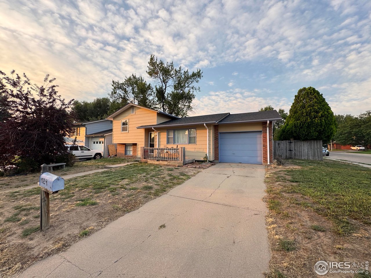 1924 30th Street Road Greeley, CO 80631 - Photo 17 of 19 a front view of a house with a yard and garage