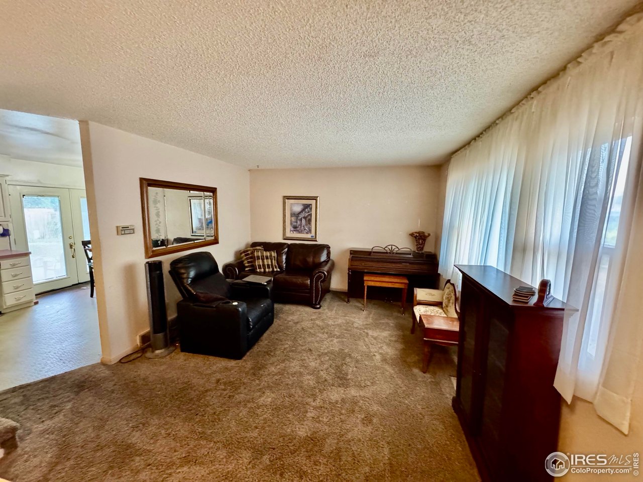 1924 30th Street Road Greeley, CO 80631 - Photo 3 of 19 a living room with furniture and a flat screen tv