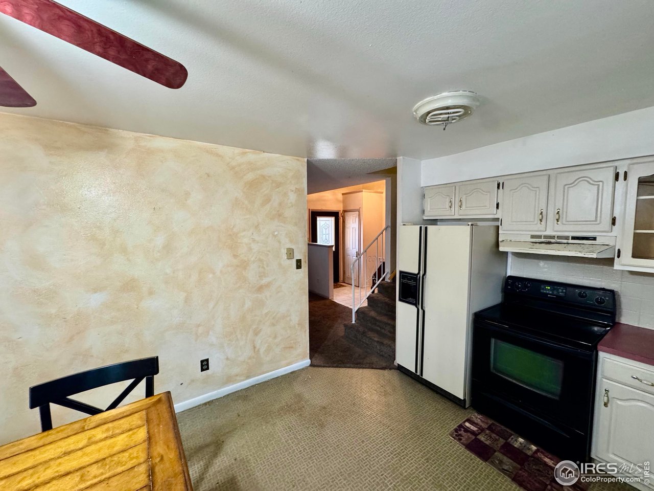 1924 30th Street Road Greeley, CO 80631 - Photo 9 of 19 a kitchen with a refrigerator and a stove