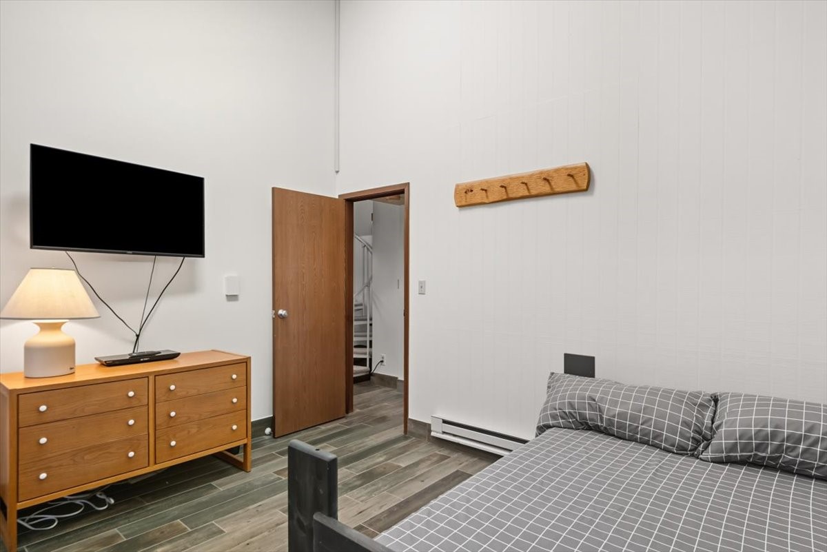 1937 Soda Ridge Road, Unit 1159 Keystone, CO 80435 - Photo 12 of 29 Bedroom featuring a high ceiling, dark wood-type flooring, and a baseboard radiator