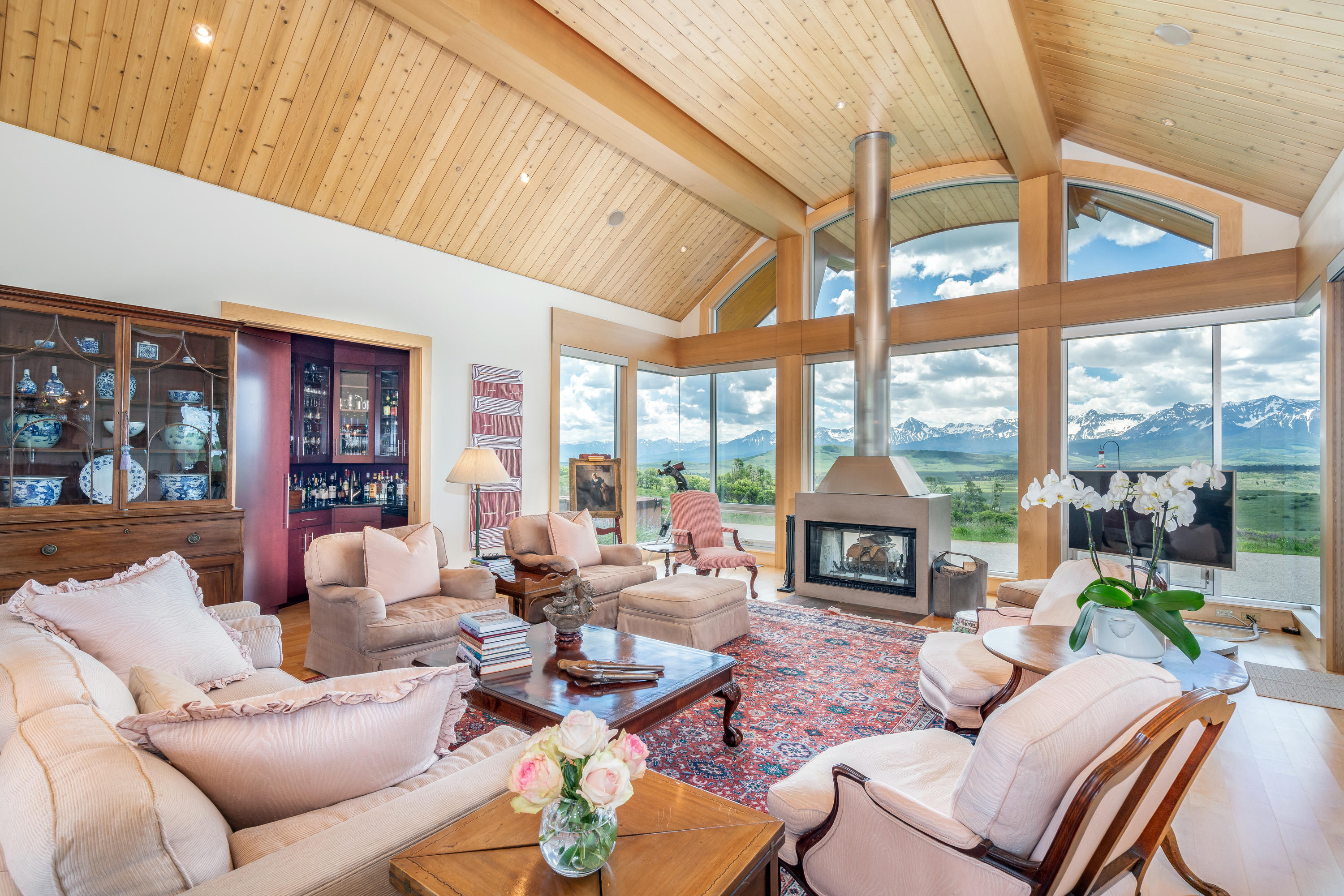 1804 Ranch Road Placerville, CO 81430 - Photo 6 of 52 a living room with furniture a fireplace and a floor to ceiling window