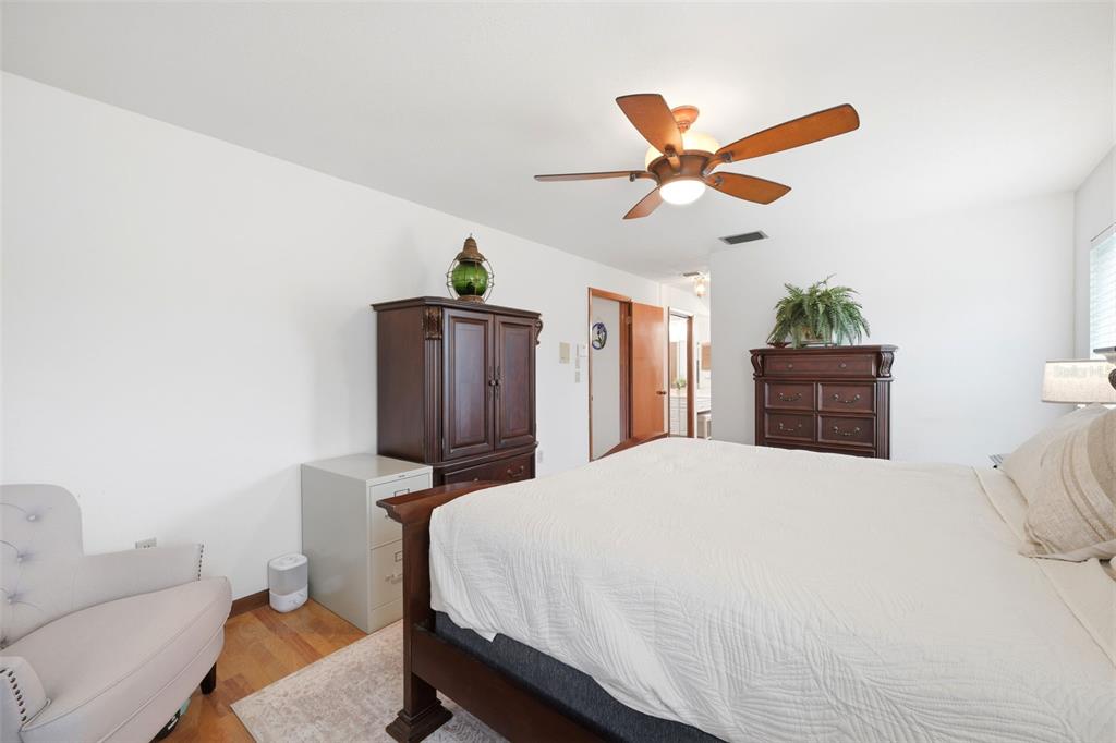 5227 Suwannee Road Weeki Wachee, FL 34607 - Photo 25 of 62 a bedroom with a bed and a chandelier