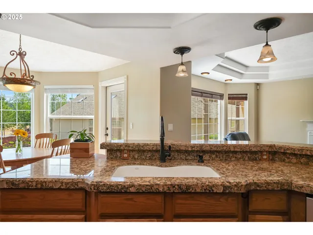 a kitchen with granite countertop a sink and a counter top space