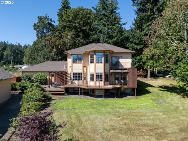 a view of a house with backyard sitting area and garden