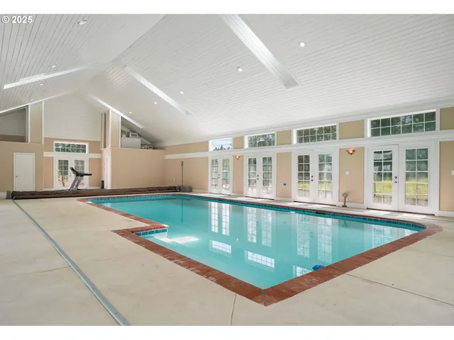 a large swimming pool is sitting in middle of a room