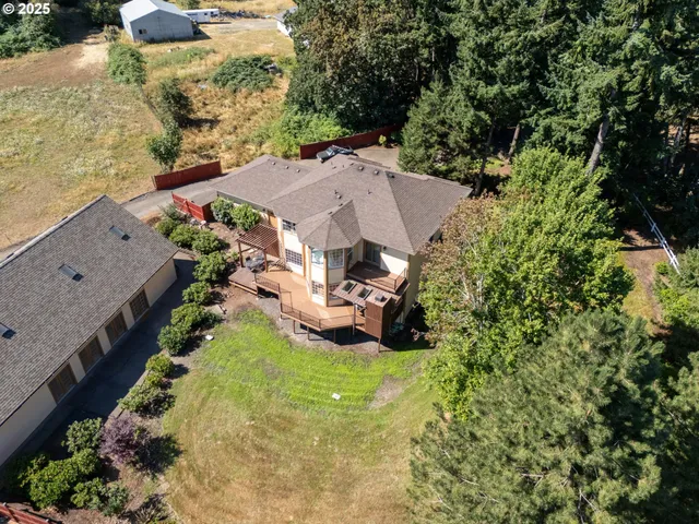 an aerial view of a house with yard swimming pool and outdoor seating
