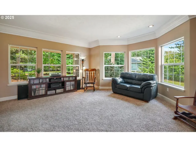 a living room with furniture and large windows