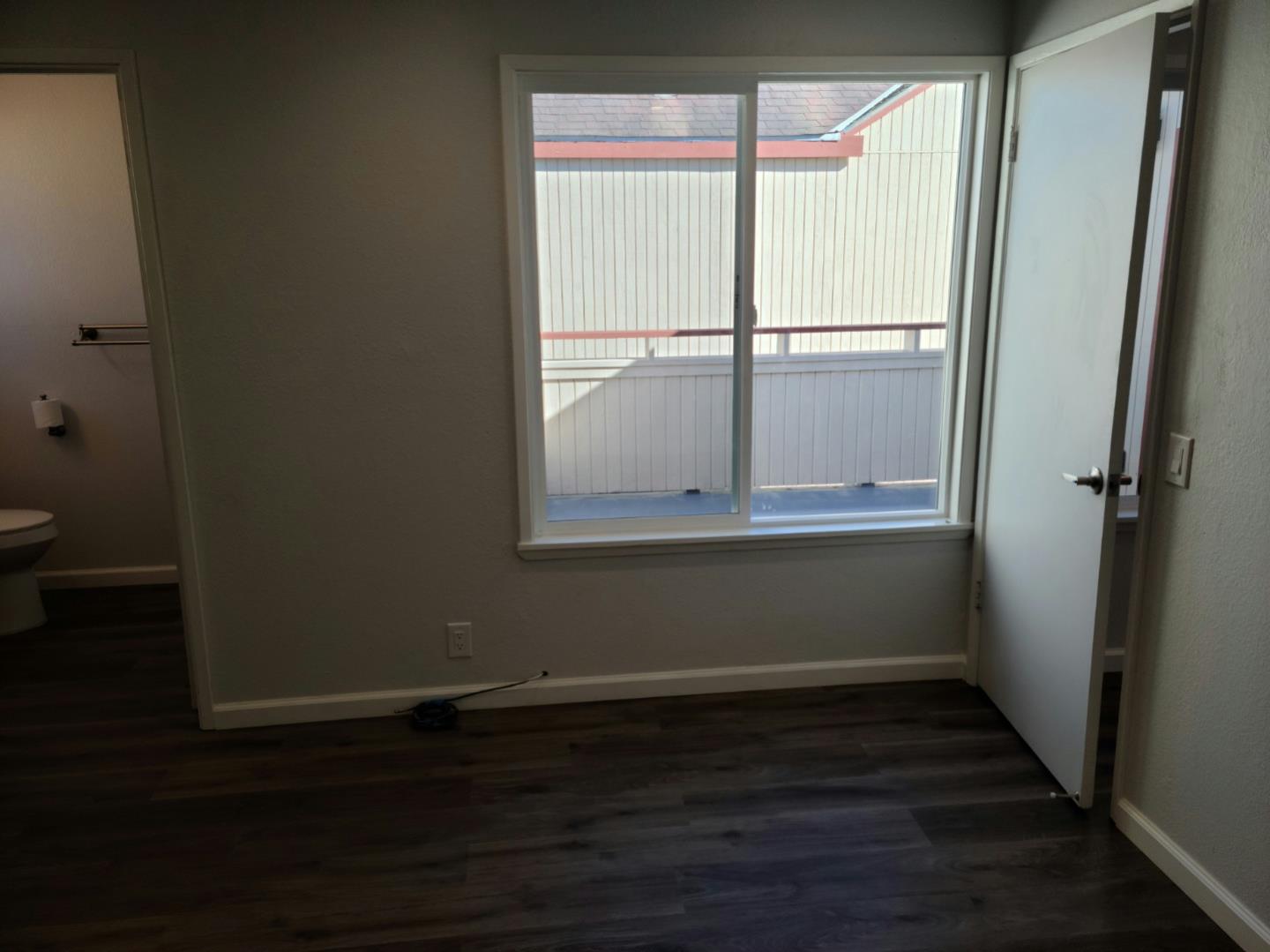 2362 North Main Street, Unit 6 Salinas, CA 93906 - Photo 11 of 21 a view of an empty room with wooden floor and a window
