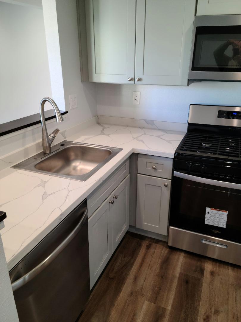 2362 North Main Street, Unit 6 Salinas, CA 93906 - Photo 16 of 21 a kitchen with granite countertop a sink dishwasher stove and cabinets
