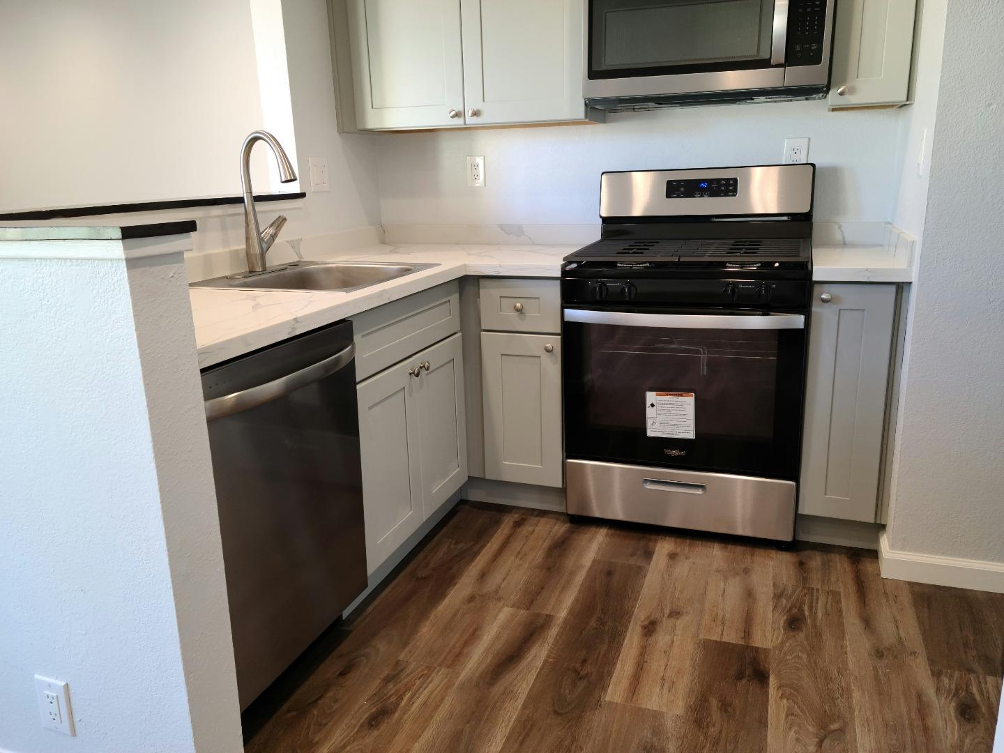 2362 North Main Street, Unit 6 Salinas, CA 93906 - Photo 17 of 21 a kitchen with stainless steel appliances granite countertop a stove microwave and sink