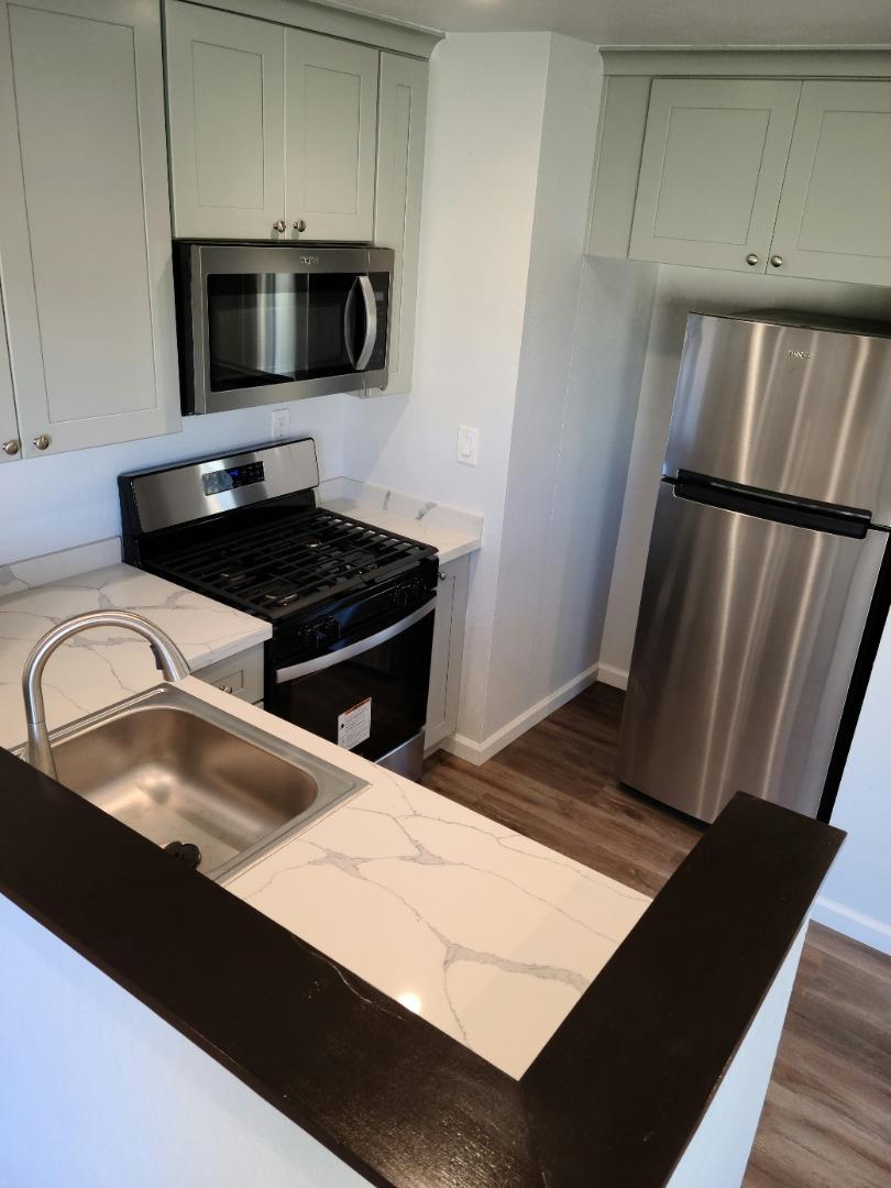 2362 North Main Street, Unit 6 Salinas, CA 93906 - Photo 18 of 21 a kitchen with stainless steel appliances a refrigerator a sink a stove and microwave