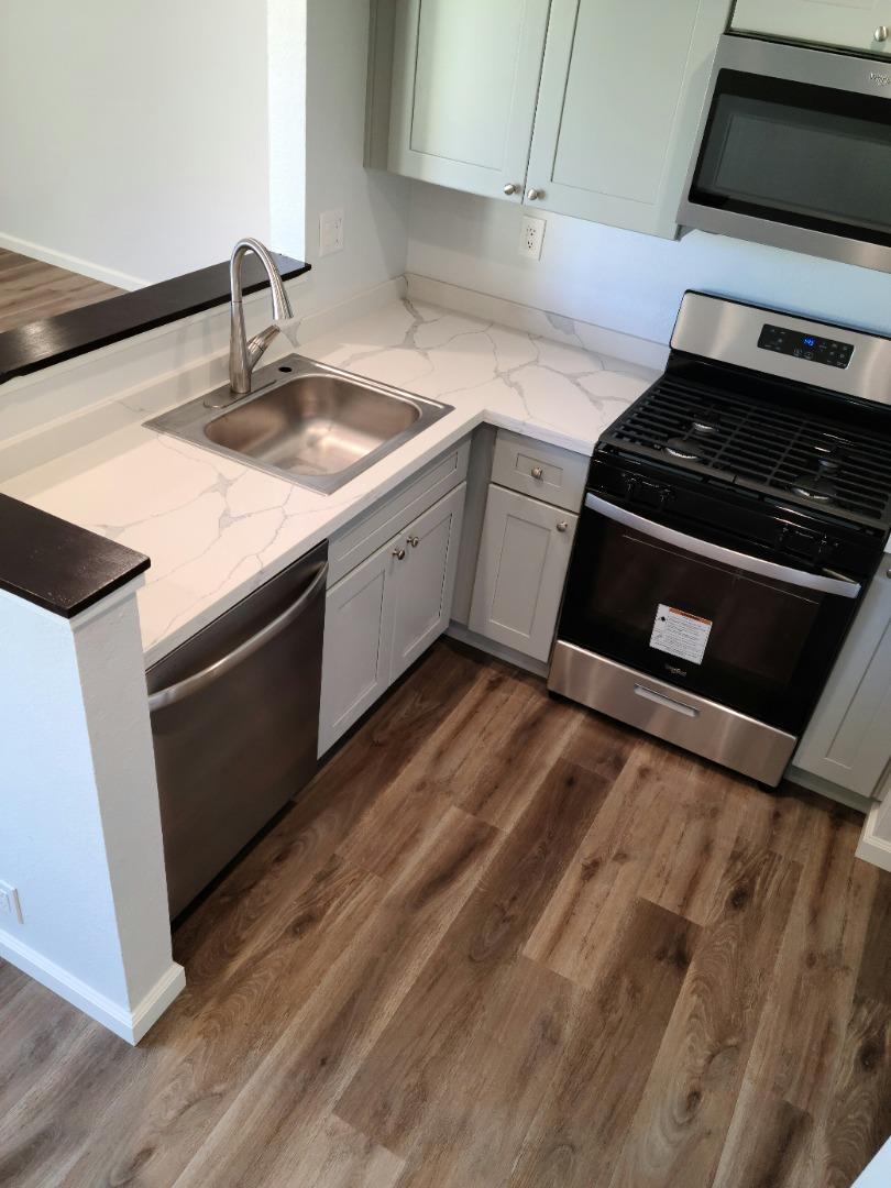 2362 North Main Street, Unit 6 Salinas, CA 93906 - Photo 6 of 21 a kitchen with granite countertop a sink and a stove