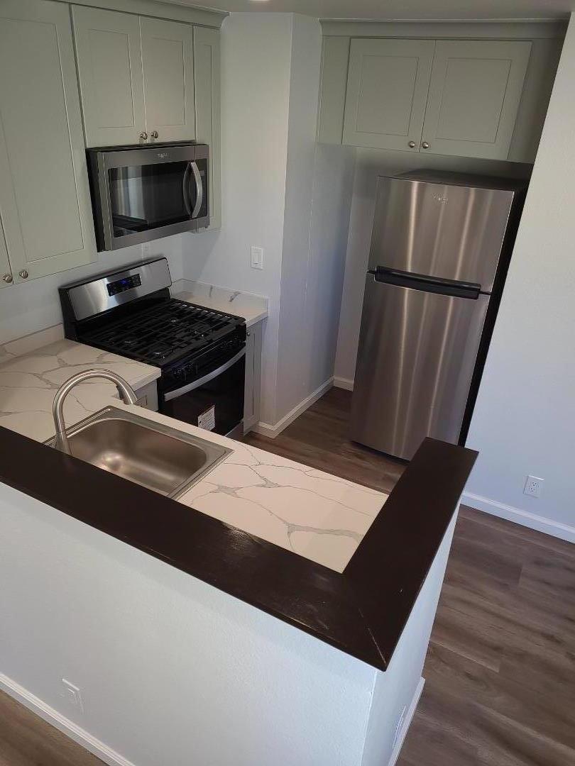 2362 North Main Street, Unit 6 Salinas, CA 93906 - Photo 7 of 21 a view of kitchen island wooden floor and electronic appliances