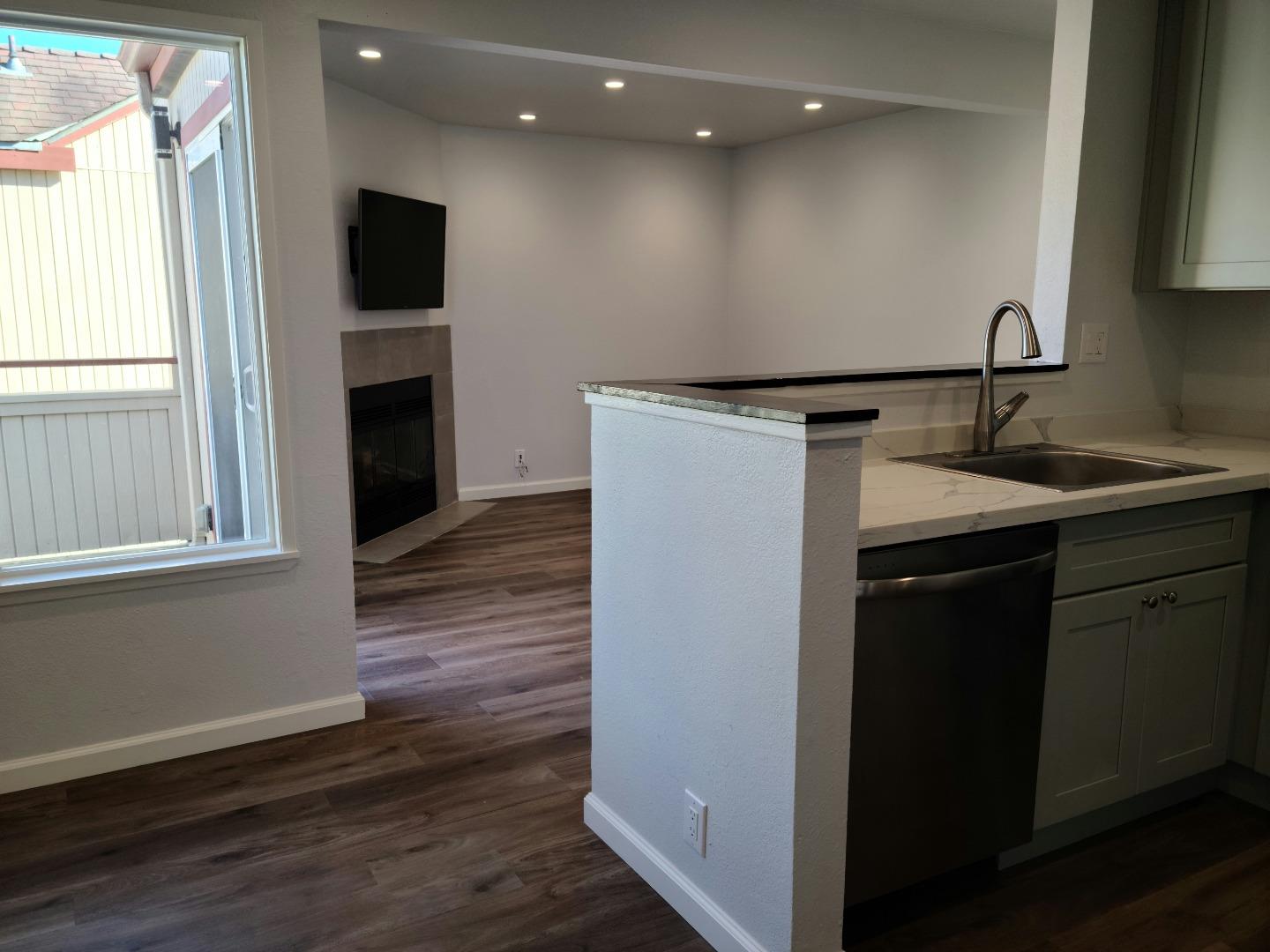2362 North Main Street, Unit 6 Salinas, CA 93906 - Photo 9 of 21 a kitchen with kitchen island a sink appliances a counter space and a window
