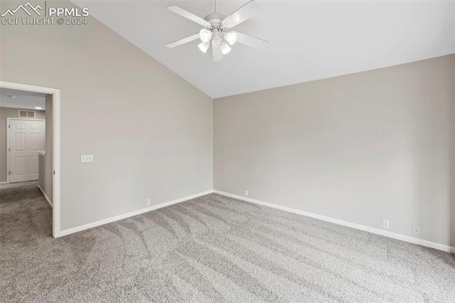6725 Akron Road Colorado Springs, CO 80923 - Photo 22 of 50 Empty room with carpet flooring, ceiling fan, and high vaulted ceiling