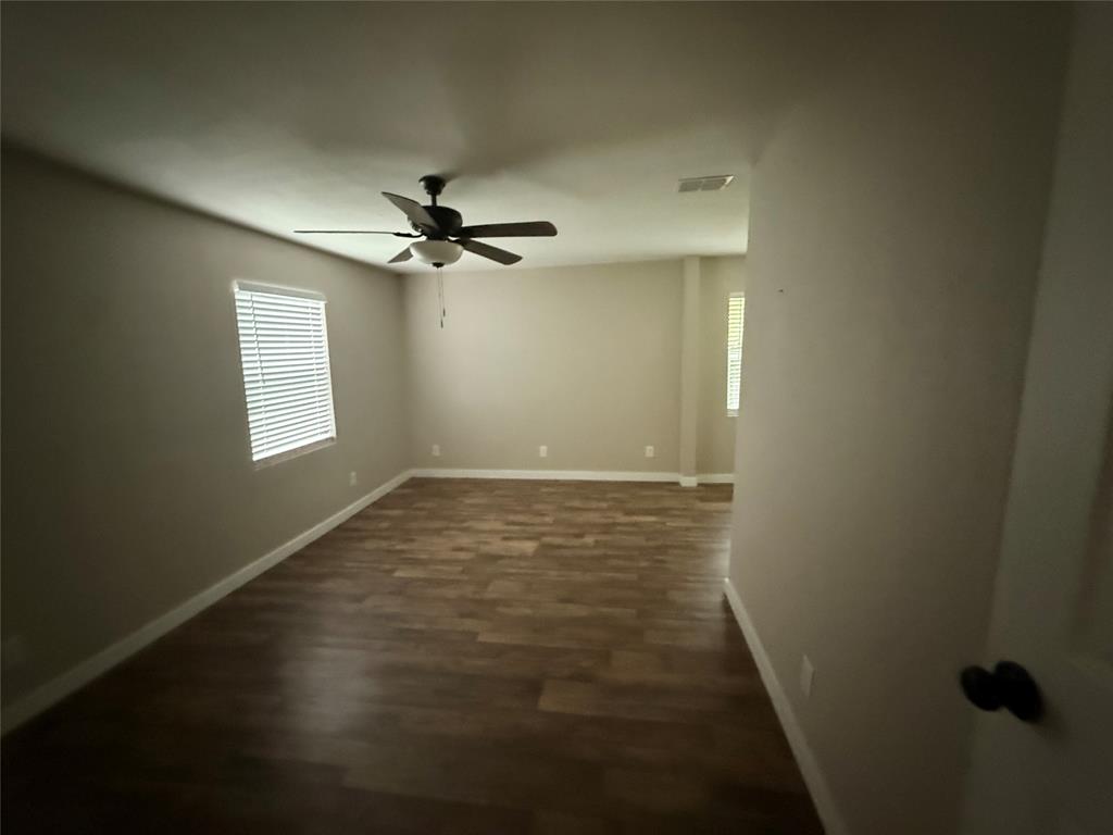515 Burgett Street Forney, TX 75126 - Photo 8 of 15 Expansive room featuring wood-finish flooring, neutral paint palette, and white baseboards