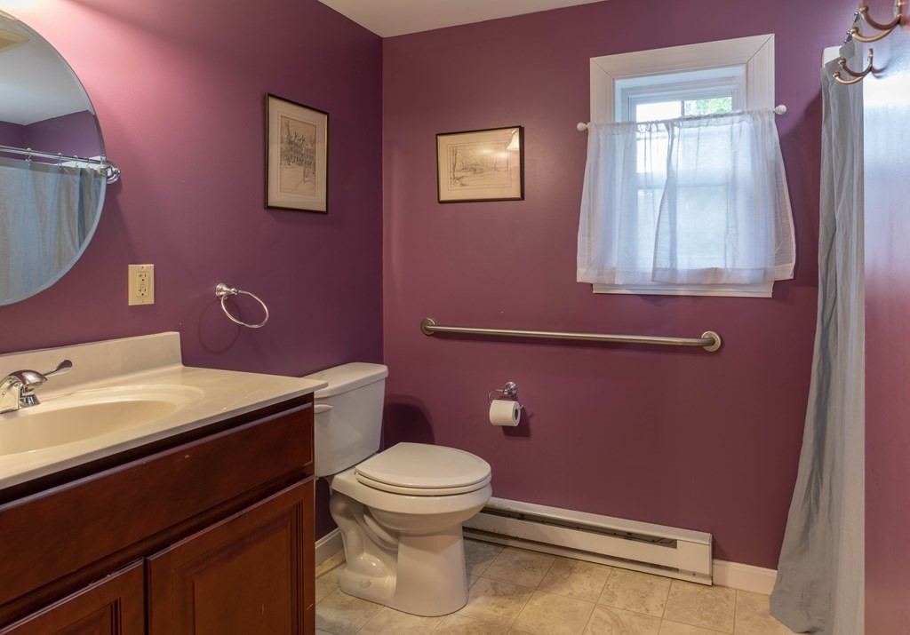 197 Bridge Road Northampton, MA 01062 - Photo 14 of 24 a bathroom with a granite countertop toilet a sink and a mirror