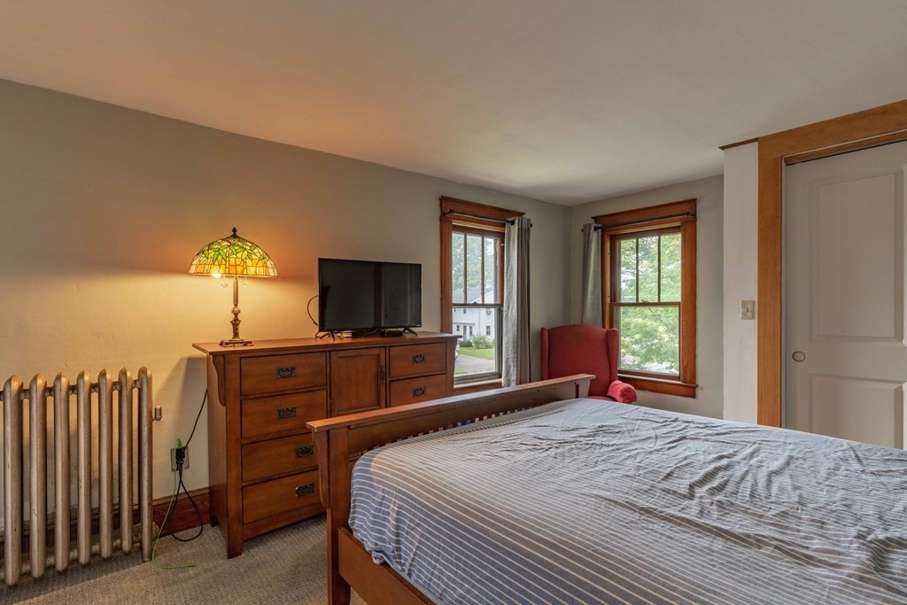 197 Bridge Road Northampton, MA 01062 - Photo 15 of 24 a bedroom with a bed and a flat screen tv