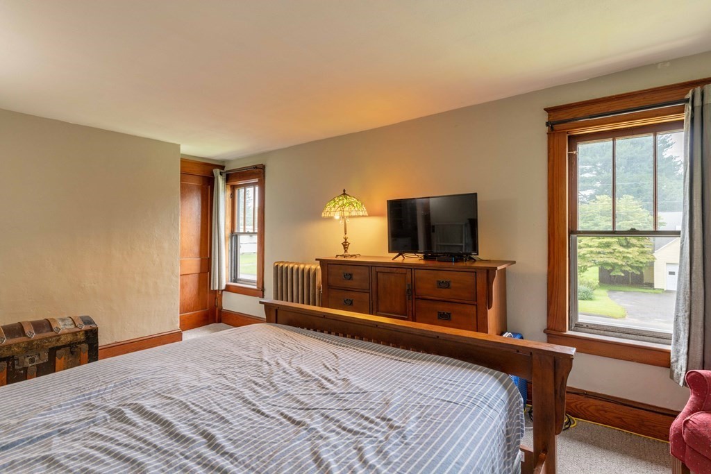 197 Bridge Road Northampton, MA 01062 - Photo 16 of 24 a bedroom with a bed and a flat screen tv