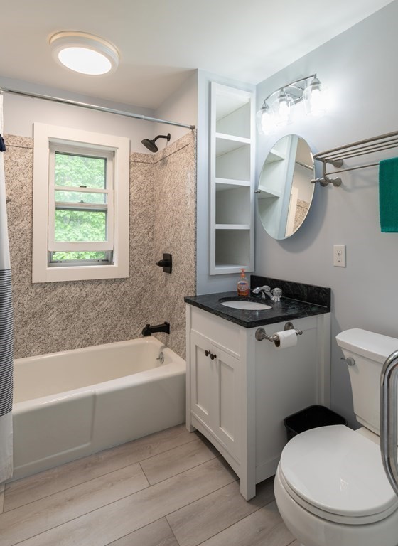 197 Bridge Road Northampton, MA 01062 - Photo 19 of 24 a bathroom with a granite countertop sink a toilet a mirror and bathtub