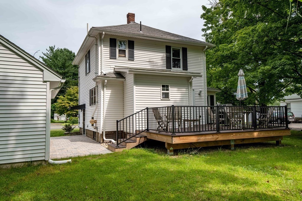 197 Bridge Road Northampton, MA 01062 - Photo 20 of 24 a white house that has a small yard and trees