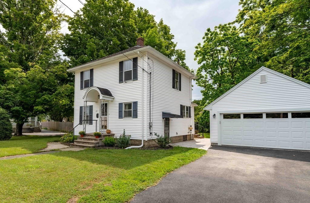 197 Bridge Road Northampton, MA 01062 - Photo 2 of 24 a view of a yard in front of a house with plants and large tree