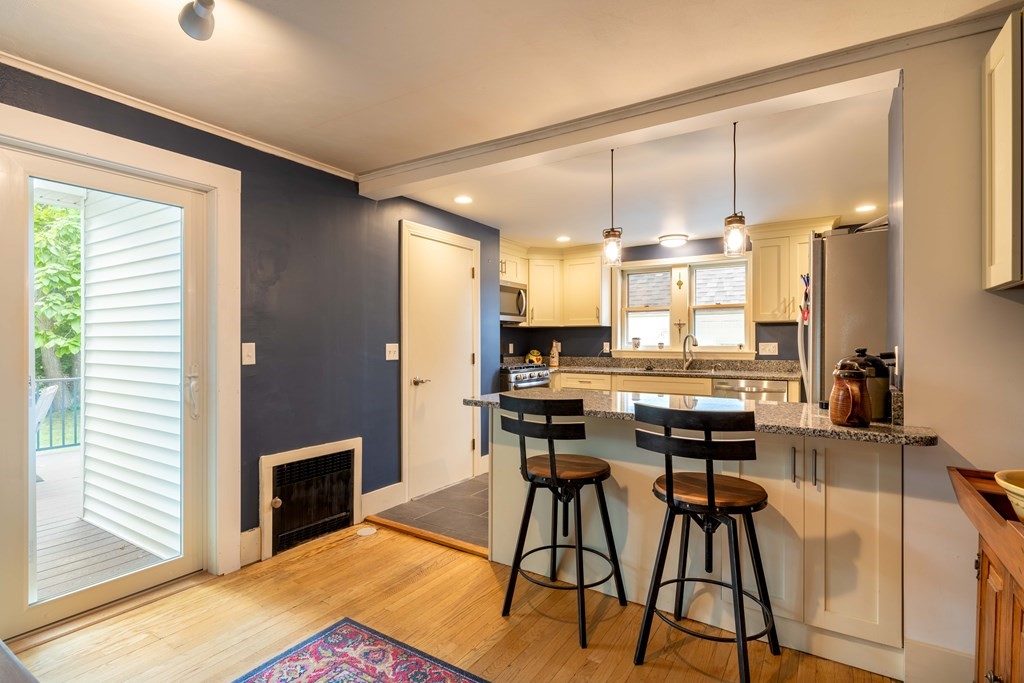 197 Bridge Road Northampton, MA 01062 - Photo 4 of 24 a kitchen with stainless steel appliances kitchen island granite countertop a stove a sink and a microwave