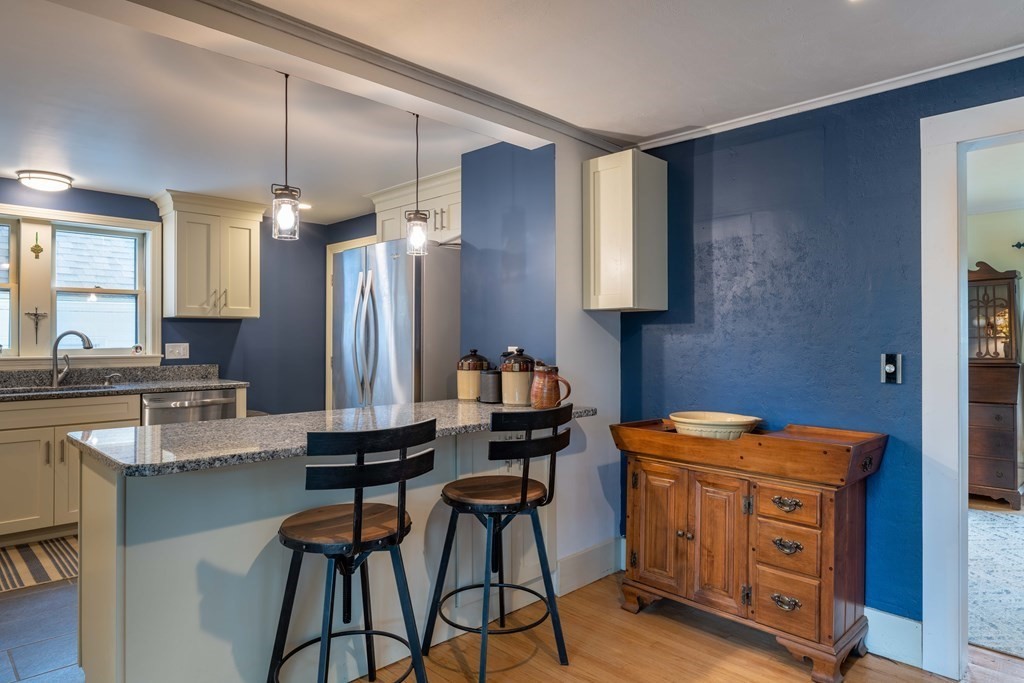 197 Bridge Road Northampton, MA 01062 - Photo 5 of 24 a kitchen with stainless steel appliances kitchen island granite countertop a stove a sink and a refrigerator